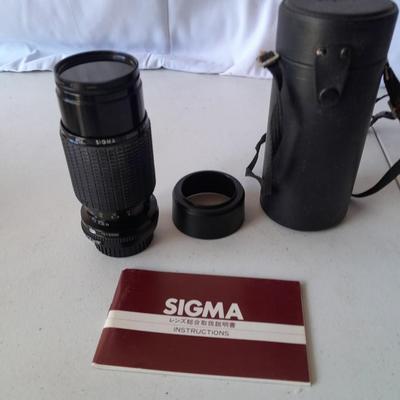 Two 35 mm camera lenses - Sigma - Vivitar 2X Tele Converter both with instructions 35mm camera