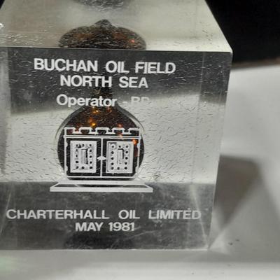 two paperweights North Sea oil field with oil and seashell