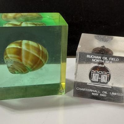 two paperweights North Sea oil field with oil and seashell