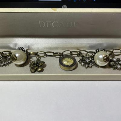 Vintage Mid-Century Antiqued Brass Charm Bracelet by Decade with Miscellaneous Charms as Pictured.