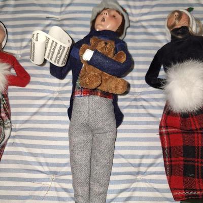 Caroler holding teddy bear