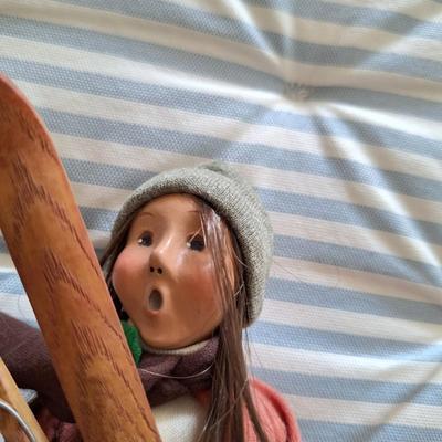 Adult Woman Holding a Pair of Skis - 2001