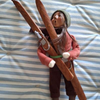 Adult Woman Holding a Pair of Skis - 2001