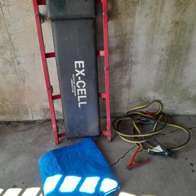 Car Creeper - Jumper cables and a used blue tarp