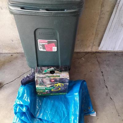 Trashcan with tarp and trash bags