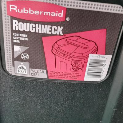 Trashcan with tarp and trash bags