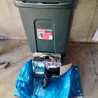 Trashcan with tarp and trash bags
