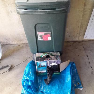 Trashcan with tarp and trash bags