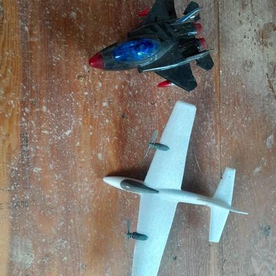 Two toy airplanes - MGA Entertainment - and Vintage roaring Tom cat Tom jet