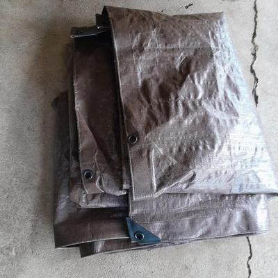 Patio Umbrella with OFF can bug away - cans of Hornet /Wasp spray and a tarp
