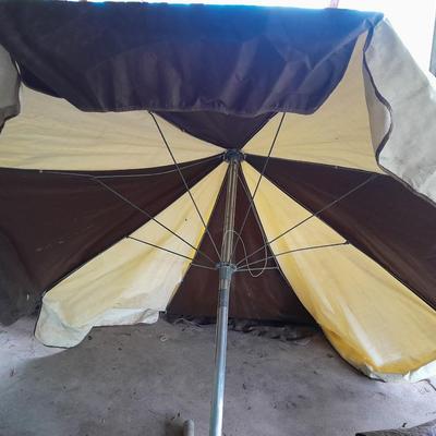 Patio Umbrella with OFF can bug away - cans of Hornet /Wasp spray and a tarp