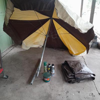 Patio Umbrella with OFF can bug away - cans of Hornet /Wasp spray and a tarp