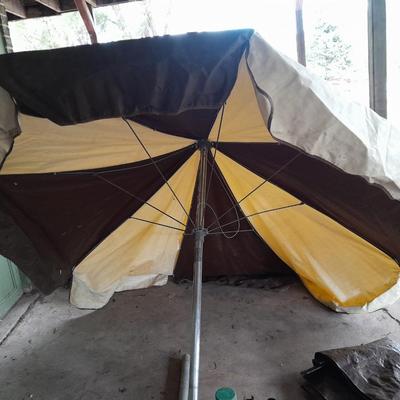 Patio Umbrella with OFF can bug away - cans of Hornet /Wasp spray and a tarp