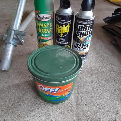 Patio Umbrella with OFF can bug away - cans of Hornet /Wasp spray and a tarp