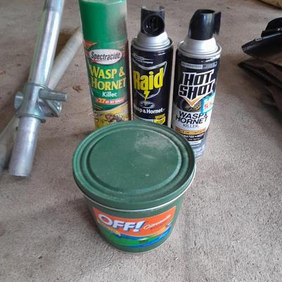 Patio Umbrella with OFF can bug away - cans of Hornet /Wasp spray and a tarp