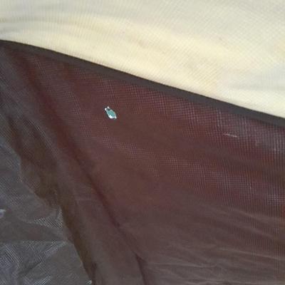 Patio Umbrella with OFF can bug away - cans of Hornet /Wasp spray and a tarp