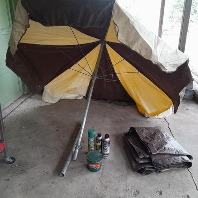 Patio Umbrella with OFF can bug away - cans of Hornet /Wasp spray and a tarp