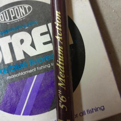 Two fishing poles and a small assortment of fishing line and hooks