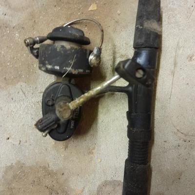 Two fishing poles and a small assortment of fishing line and hooks