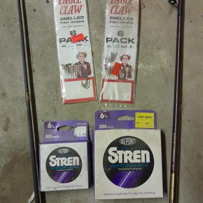 Two fishing poles and a small assortment of fishing line and hooks