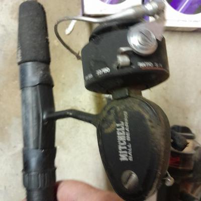 Two fishing poles and a small assortment of fishing line and hooks
