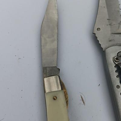 Two Pocket knives - Lakota with advertisement