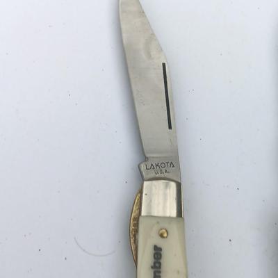 Two Pocket knives - Lakota with advertisement