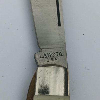 Two Pocket knives - Lakota with advertisement