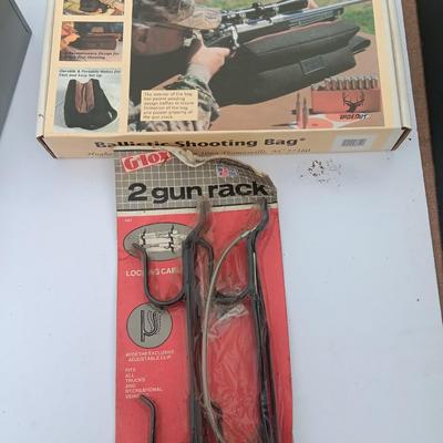 Old new stock Window mount gun rack and a Ballistic shooting bag with gun cleaning items