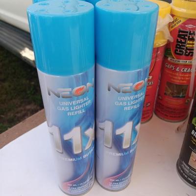 Assortment of household goods - bottles of butane - spray foam - a brush assortment and more