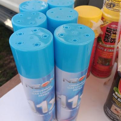 Assortment of household goods - bottles of butane - spray foam - a brush assortment and more