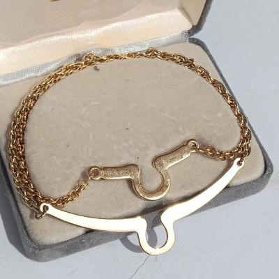 Gold toned "Boss" keychain and two gold toned matching bracelets