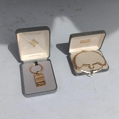 Gold toned "Boss" keychain and two gold toned matching bracelets