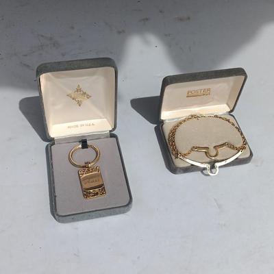 Gold toned "Boss" keychain and two gold toned matching bracelets