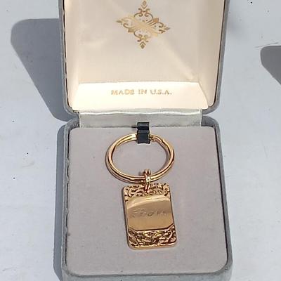 Gold toned "Boss" keychain and two gold toned matching bracelets