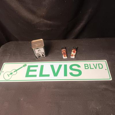 ELVIS BLVD PLASTIC SIGN, 2 DISPOSABLE LIGHTERS AND A TIN COIN BANK