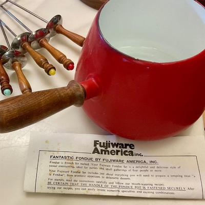 Vintage red fondue set, has original instructions, base, warmer, skewers, and pot