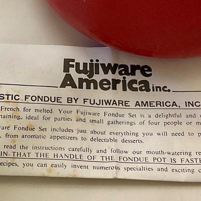 Vintage red fondue set, has original instructions, base, warmer, skewers, and pot