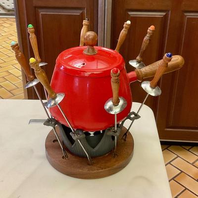 Vintage red fondue set, has original instructions, base, warmer, skewers, and pot