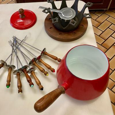 Vintage red fondue set, has original instructions, base, warmer, skewers, and pot