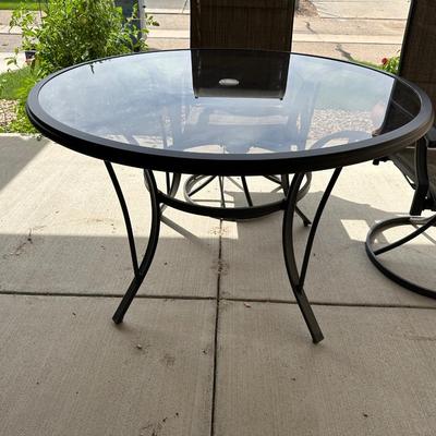 GLASS TOP PATIO TABLE WITH 4 SWIVEL CHAIRS