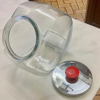 Tilted storage jar with Chrome lid and red knob