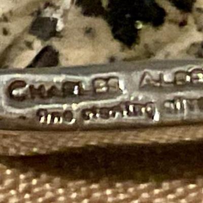 Pendant dog figure wrapped in silver bezel