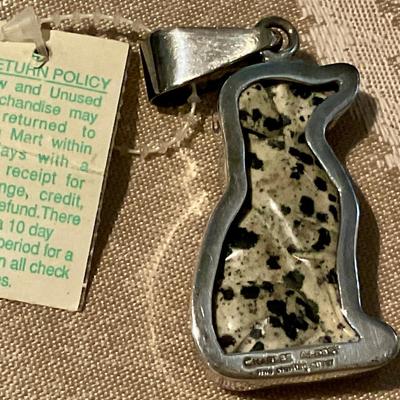 Pendant dog figure wrapped in silver bezel