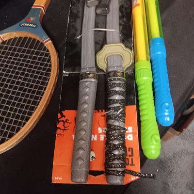 PRETEND SWORDS, WATER SQUIRTERS AND A WOODEN TENNIS RACQUET
