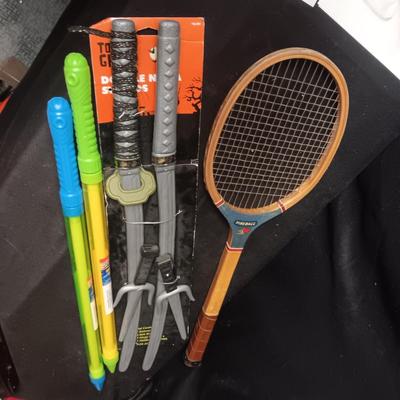 PRETEND SWORDS, WATER SQUIRTERS AND A WOODEN TENNIS RACQUET