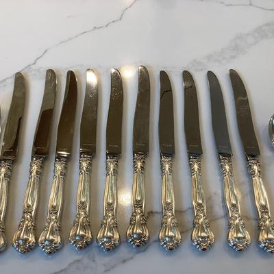 Silver- 10 luncheon knives, 10 cream soup spoon, 12 luncheon forks