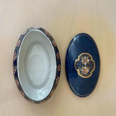 Blue and White Porcelain Oval Box with lid featuring Gold Trim and Enameled Floral Motif