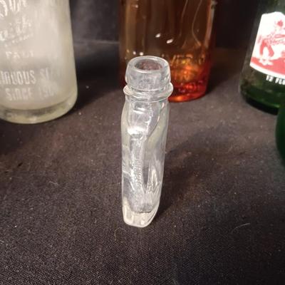 AN ASSORTMENT OF VINTAGE GLASS BOTTLES