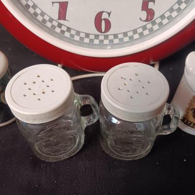 METAL FRAMED WALL CLOCK WITH GLASS FRONT AND 3 SETS OF SHAKERS